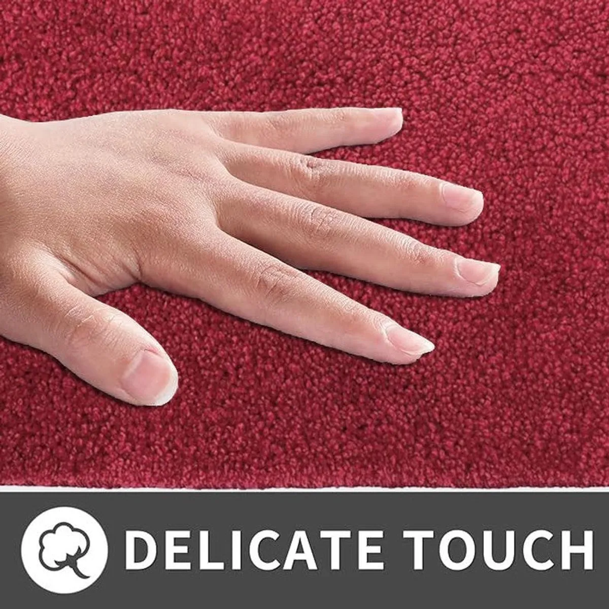 Close-up view of a hand touching the soft maroon mat surface