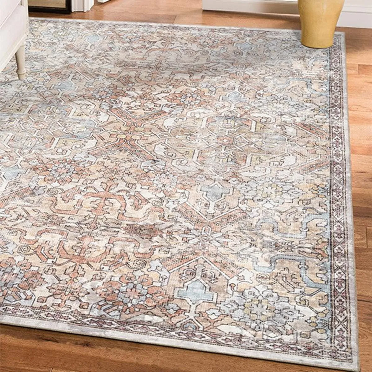Close view of beige patterned carpet spread on a wooden floor