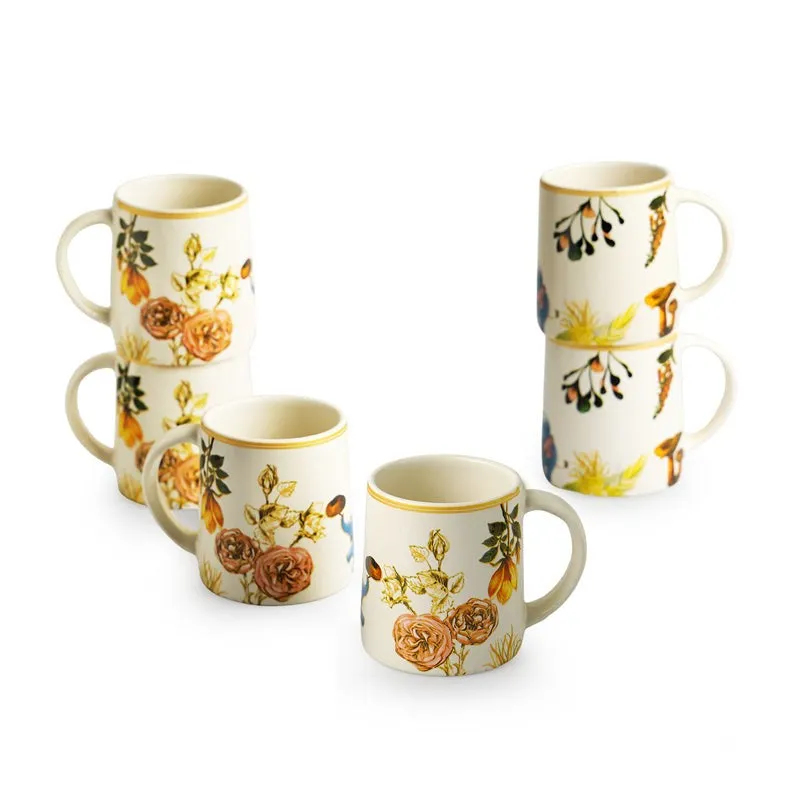 Set of floral printed white tea cups arranged against a plain white background
