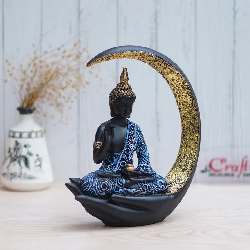 Side view of Buddha idol seated within a gold-lined crescent frame