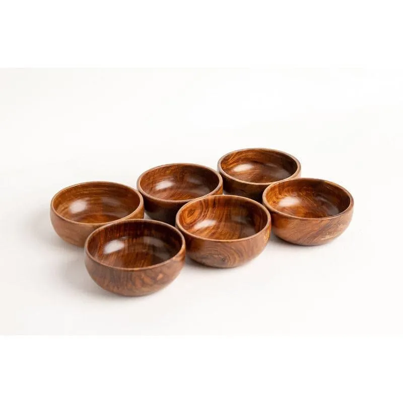 Set of six round brown wooden bowls grouped together