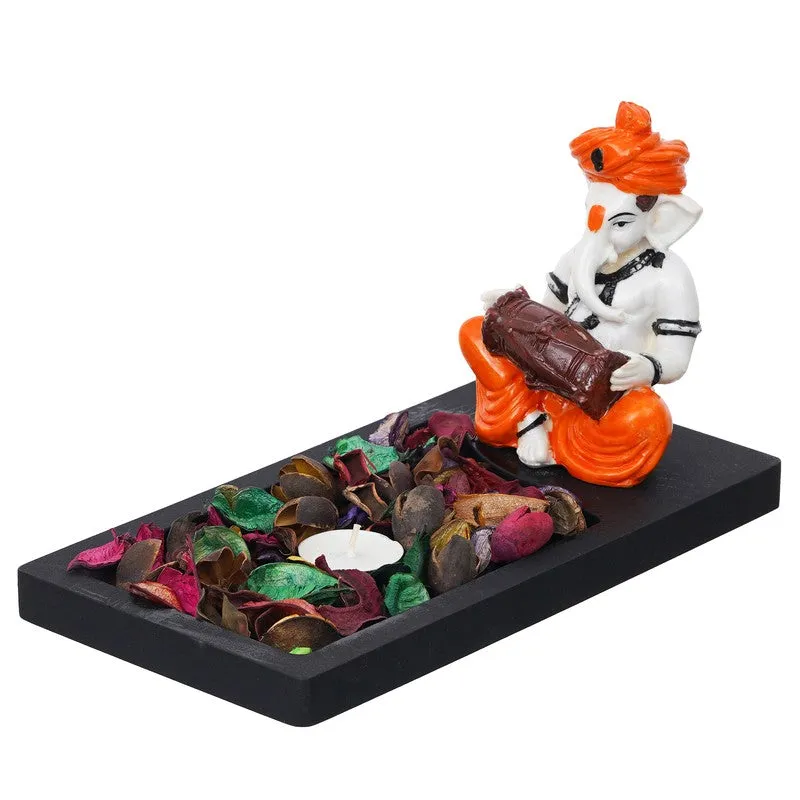 Side view of Ganesha tea light holder on a black rectangular tray base