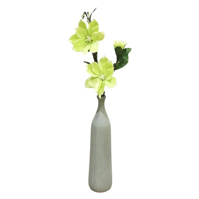 Full view of green artificial magnolia flower stick on a white background