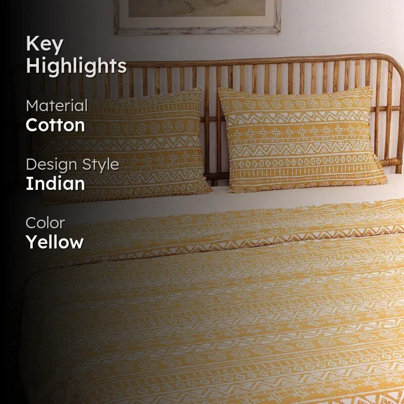 Yellow patterned dohar shown on a bed in a bedroom setting