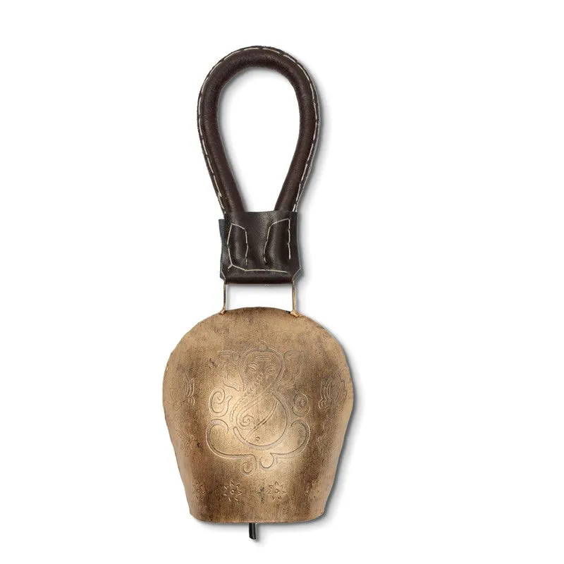 Front view of a gold bell with an ornate central motif and hanging loop