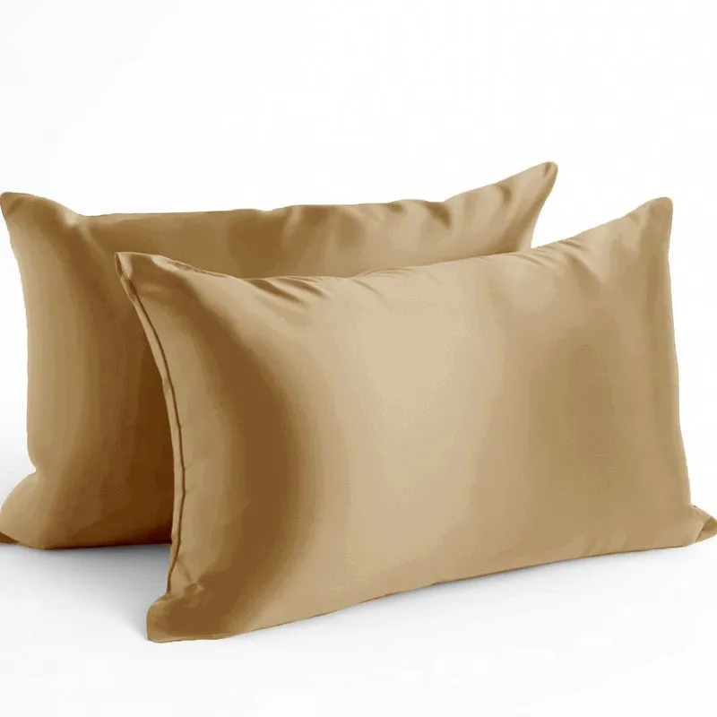 Two gold satin pillow covers shown against a white background.