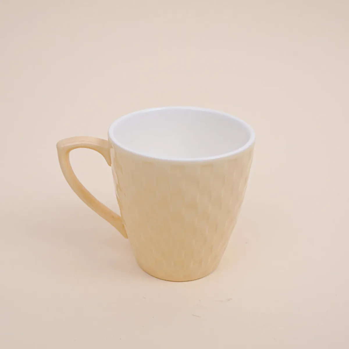 Ivory porcelain tea cup with a glossy basket-weave texture on a neutral background