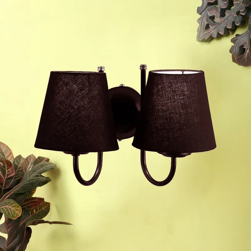 Front view of a black twin-shade wall lamp