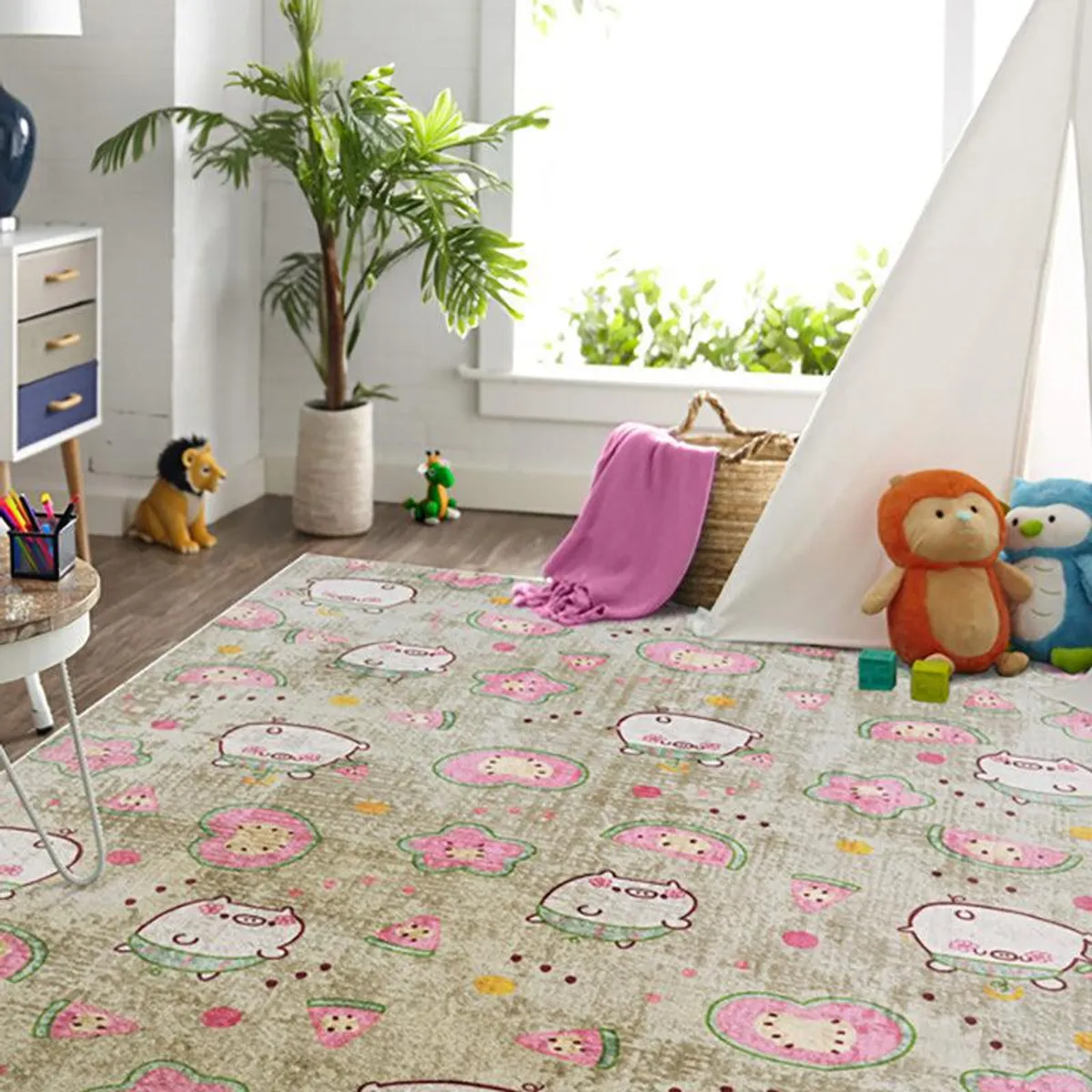Kids rectangular carpet in beige with pink and green playful cartoon print in a room setting