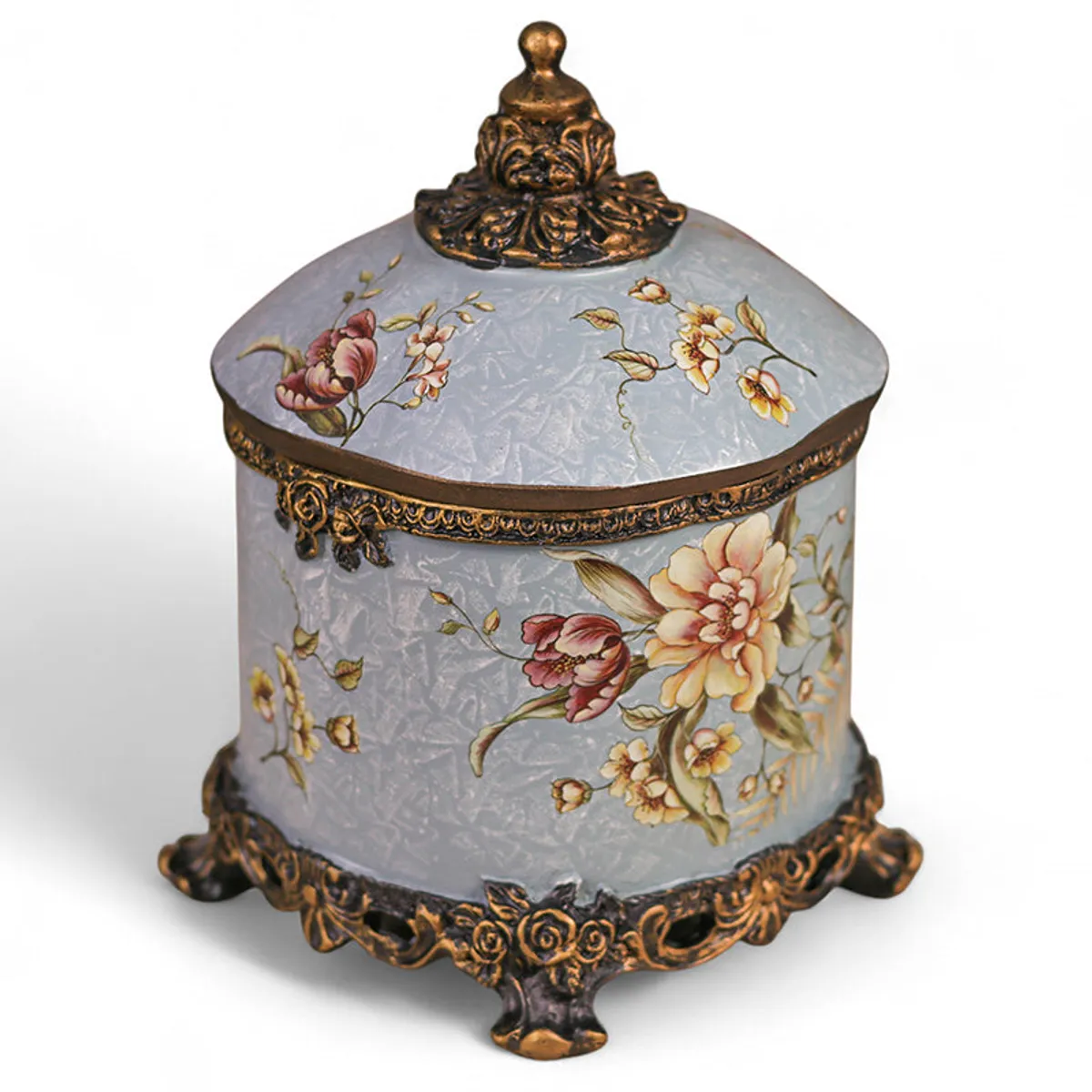 Angled view of blue floral jewel box with decorative gold detailing