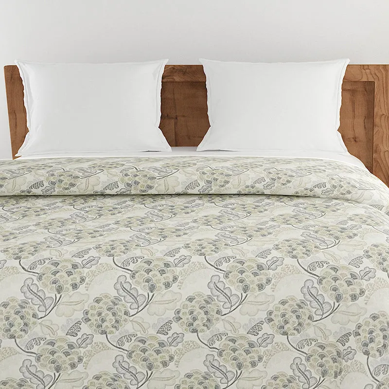 Close-up of grey and off-white floral comforter on bed