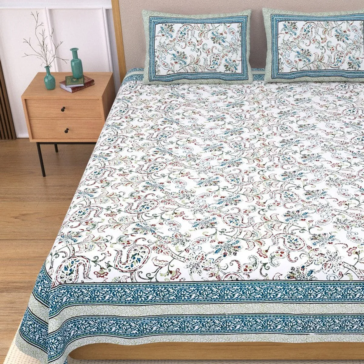 Close view of the floral paisley bedsheet and patterned blue border