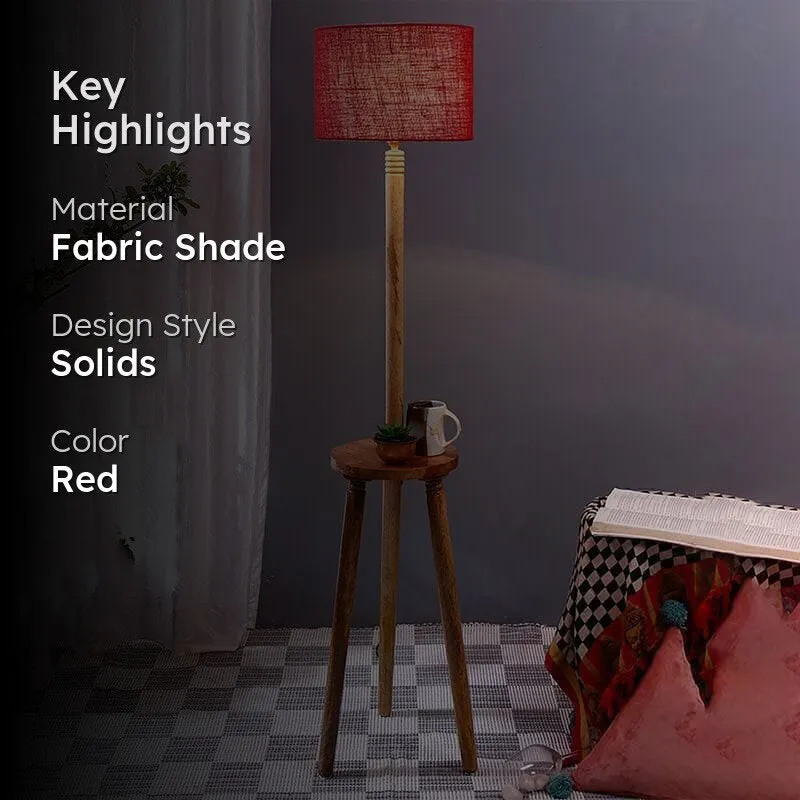 Red floor lamp with wooden tripod base and textured fabric shade