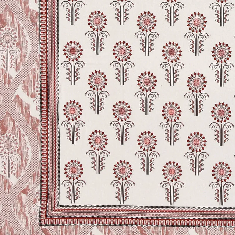 Close-up of floral motif and border on the pink and white bedsheet