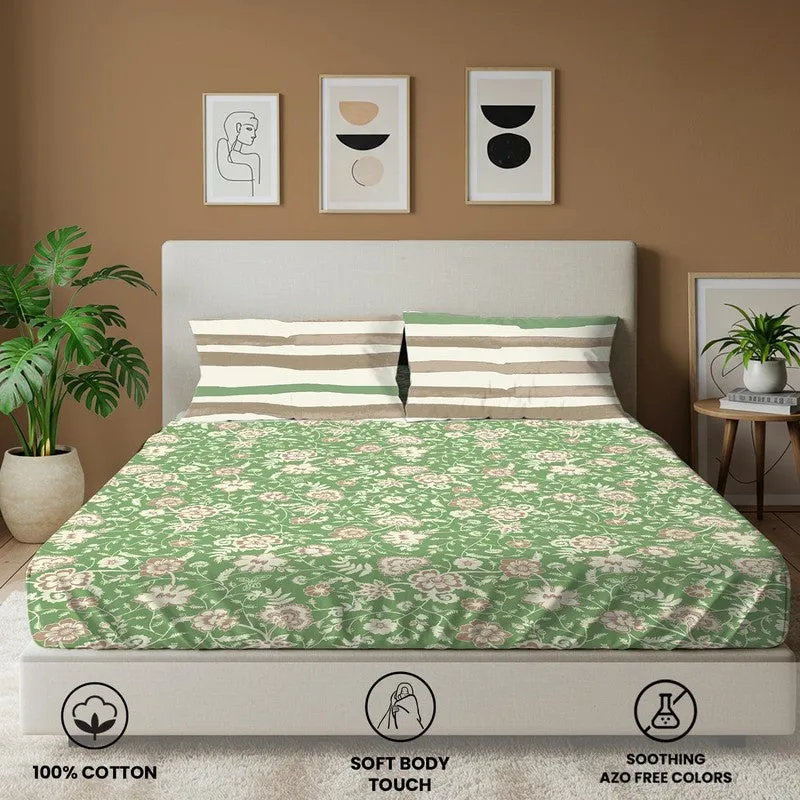 Front view of green floral bedsheet on a bed with striped pillow covers