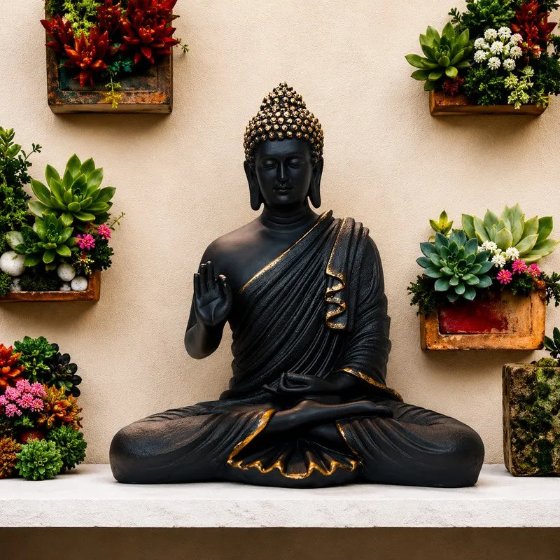 Black and gold Buddha idol in a seated meditative pose on a shelf