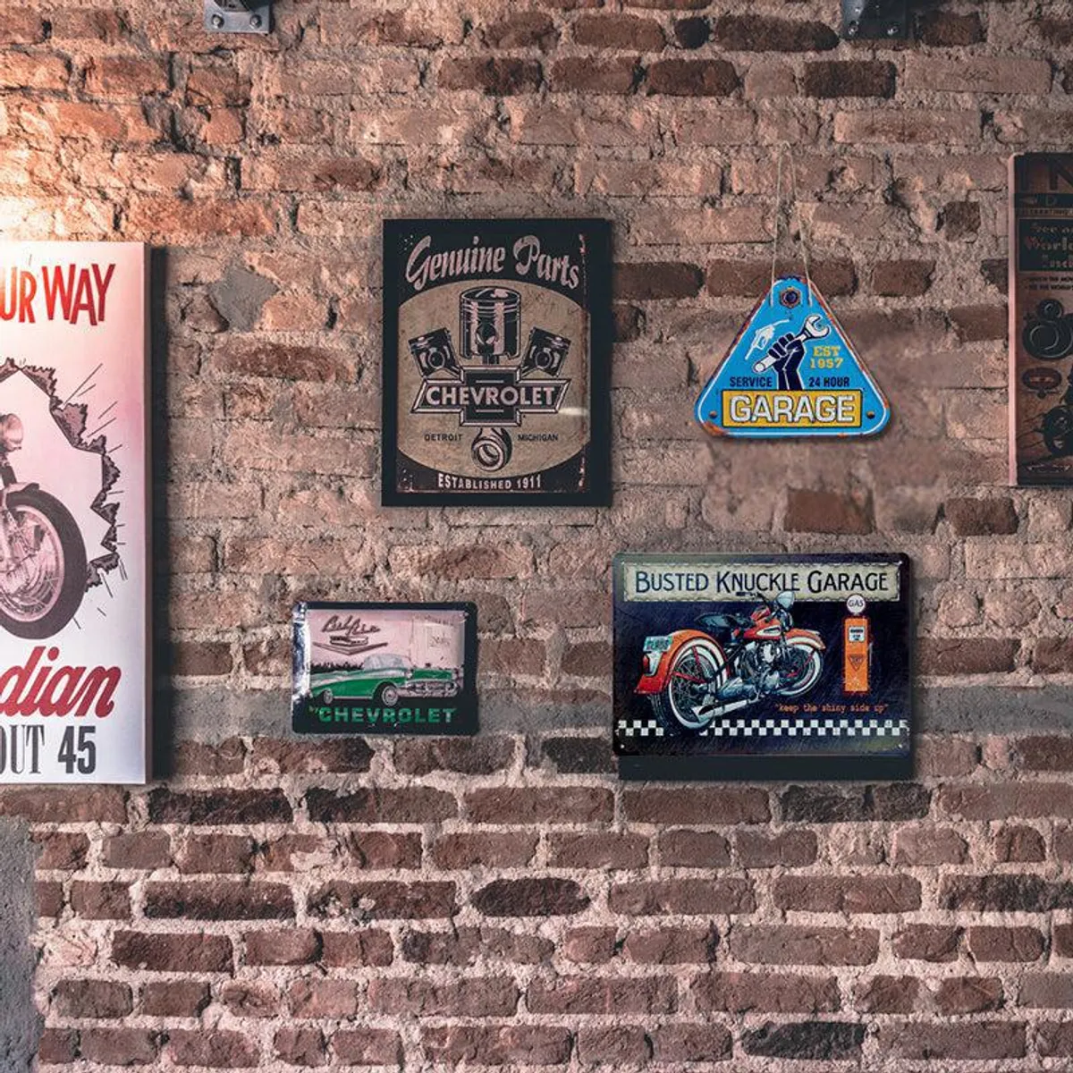 Retro automobile and garage-themed wall accents arranged against a brick wall.