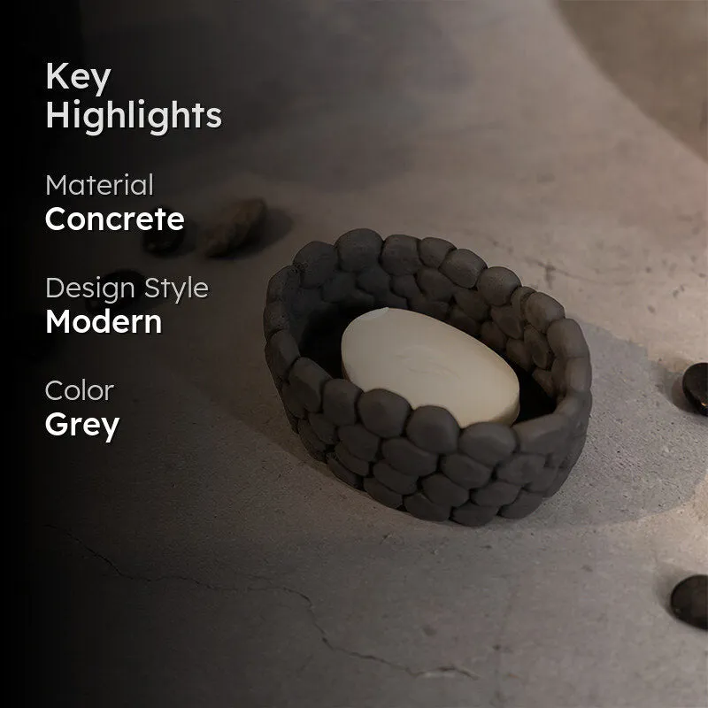 Grey textured accent bowl styled with soap on a stone-like surface