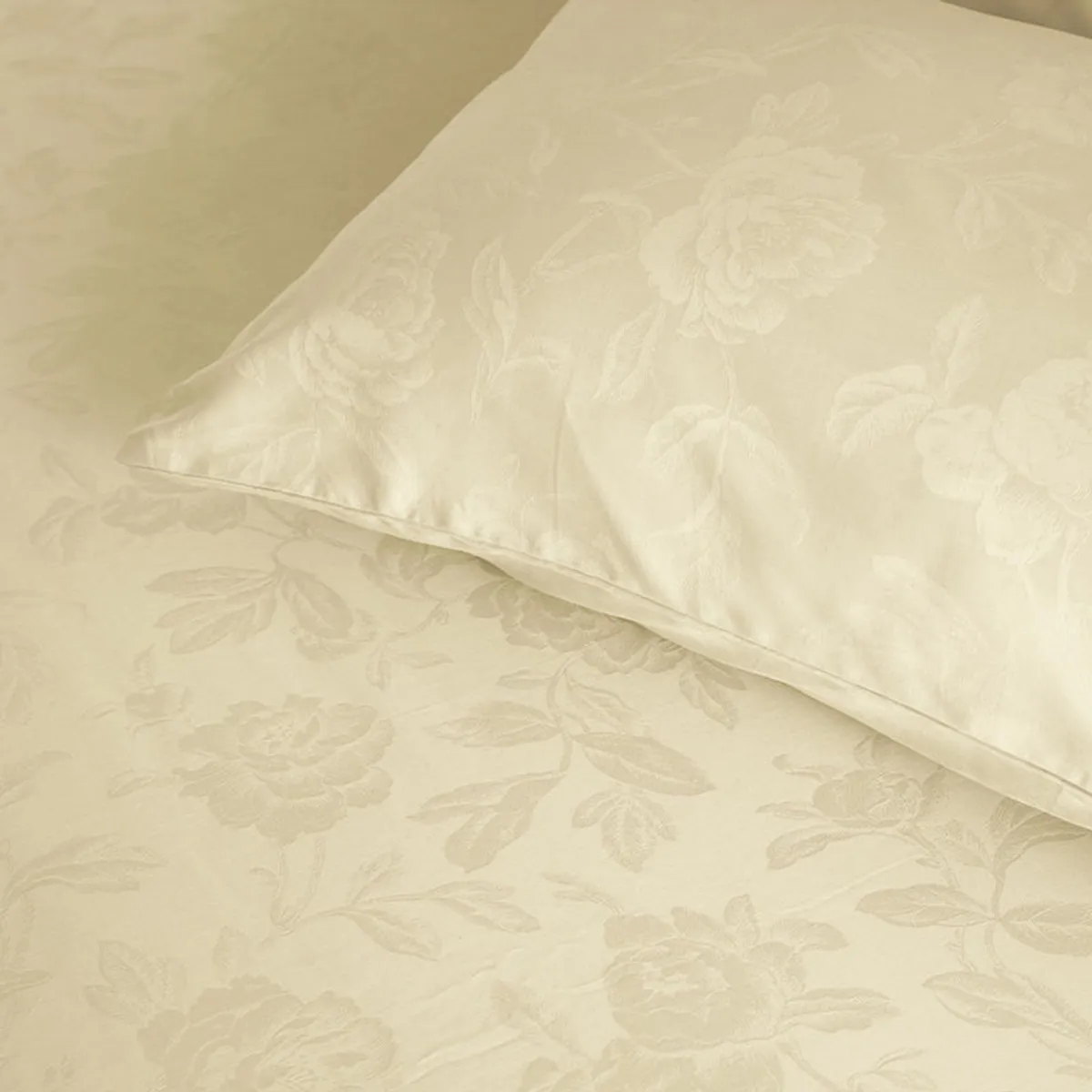 Close-up of the ivory floral pattern on the bedsheet