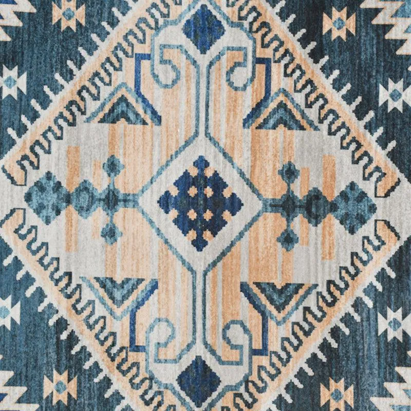 Close-up view of the carpet's intricate blue, white and beige geometric motif