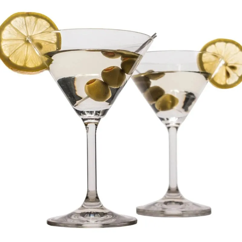 Two clear stemmed cocktail glasses with olives and lemon slices
