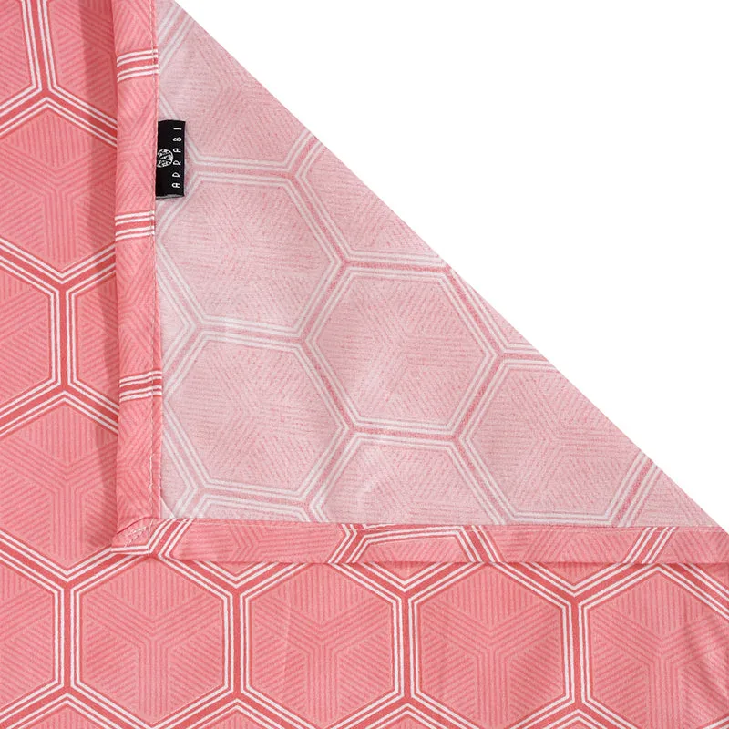 Corner detail of pink geometric bedsheet fabric