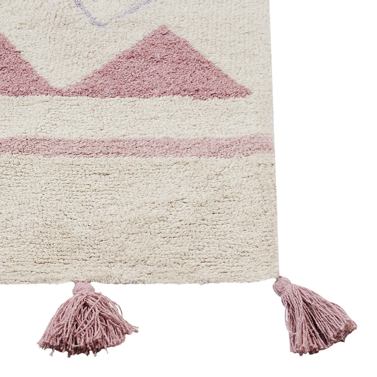Close-up of the cream rug edge with pink tassels and geometric bands