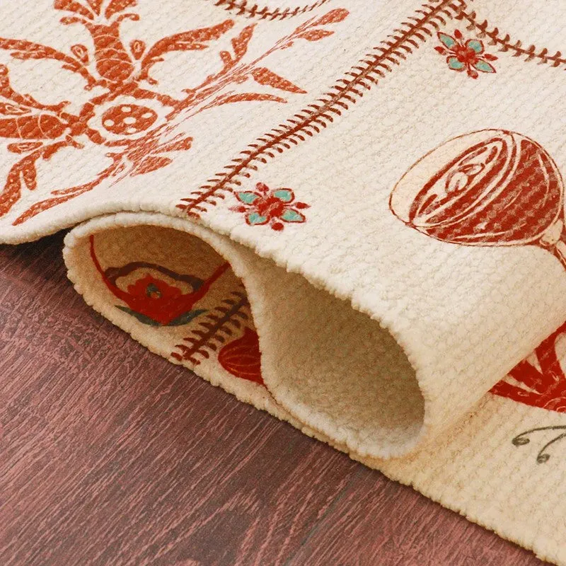 Rolled edge of the carpet showing printed motifs and textured surface