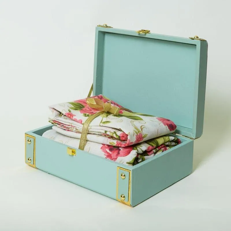Floral bedsheet set inside an open mint green gift box