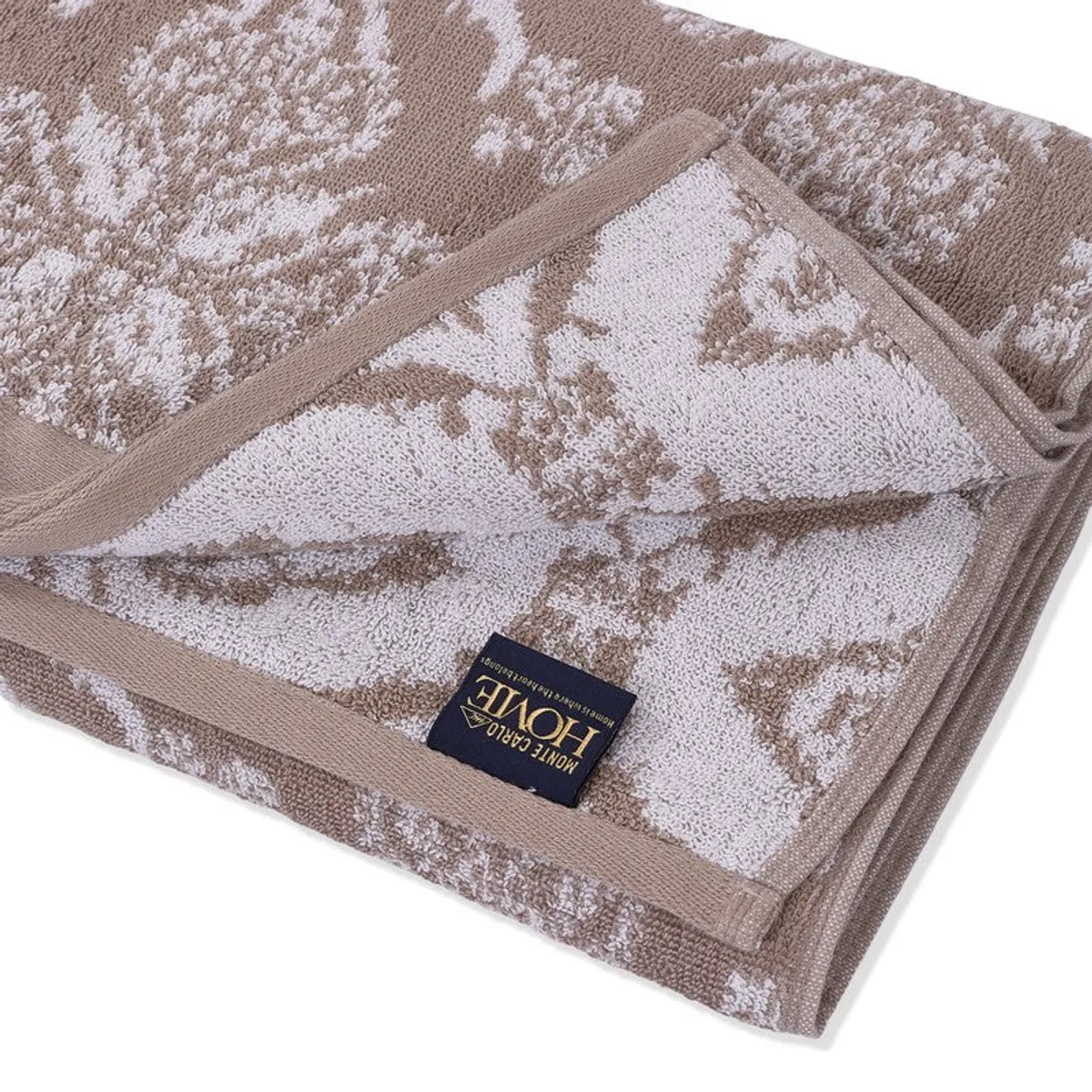 Close-up of the towel's soft floral terry texture and bordered edge