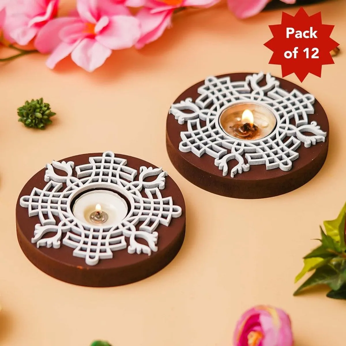 Two round brown and white tea light holders with floral decor