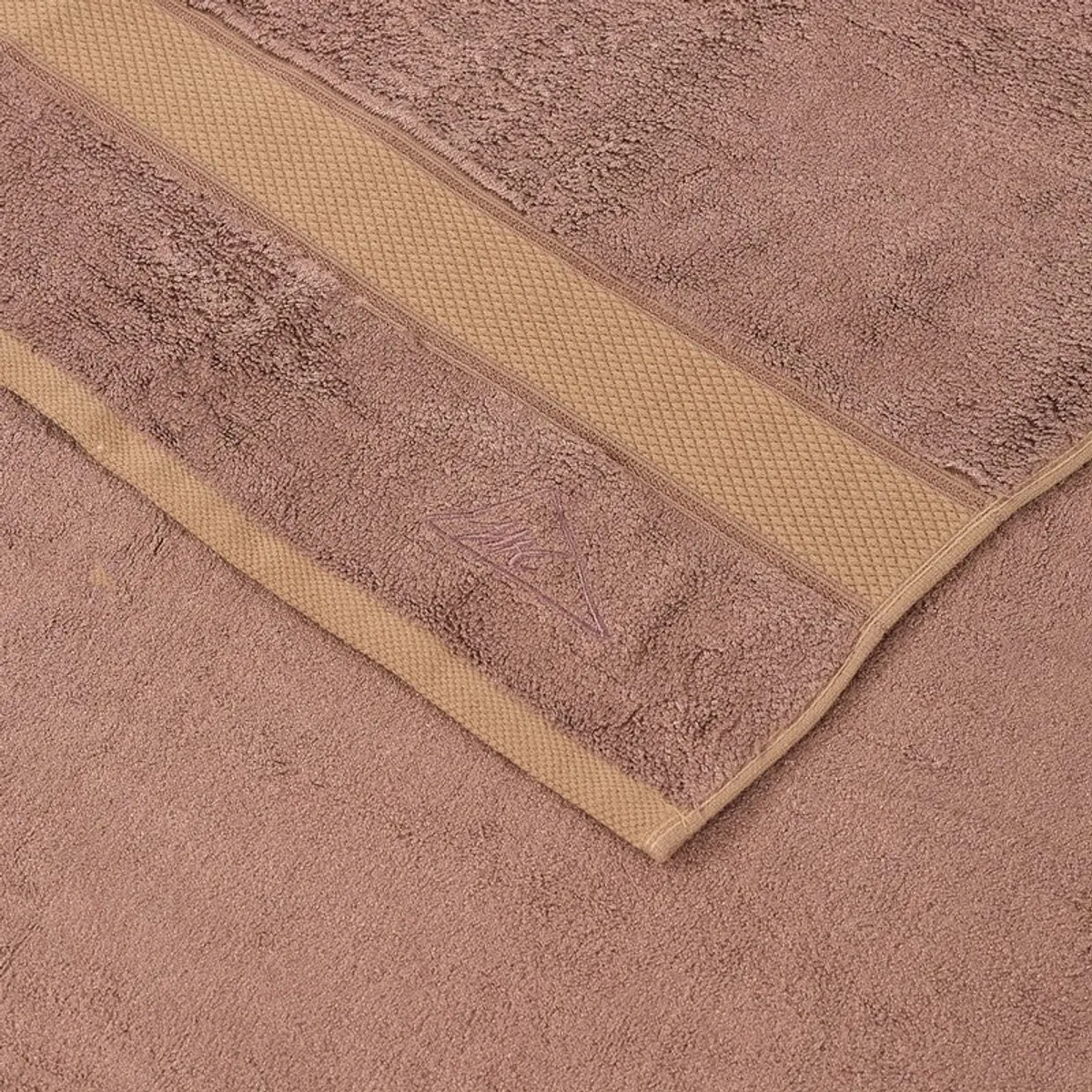 Close-up of camel-brown towel with textured contrasting bands