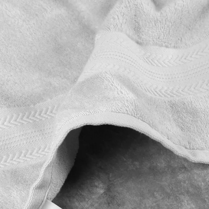 Close-up of the white towel showing its plush texture and patterned bands.