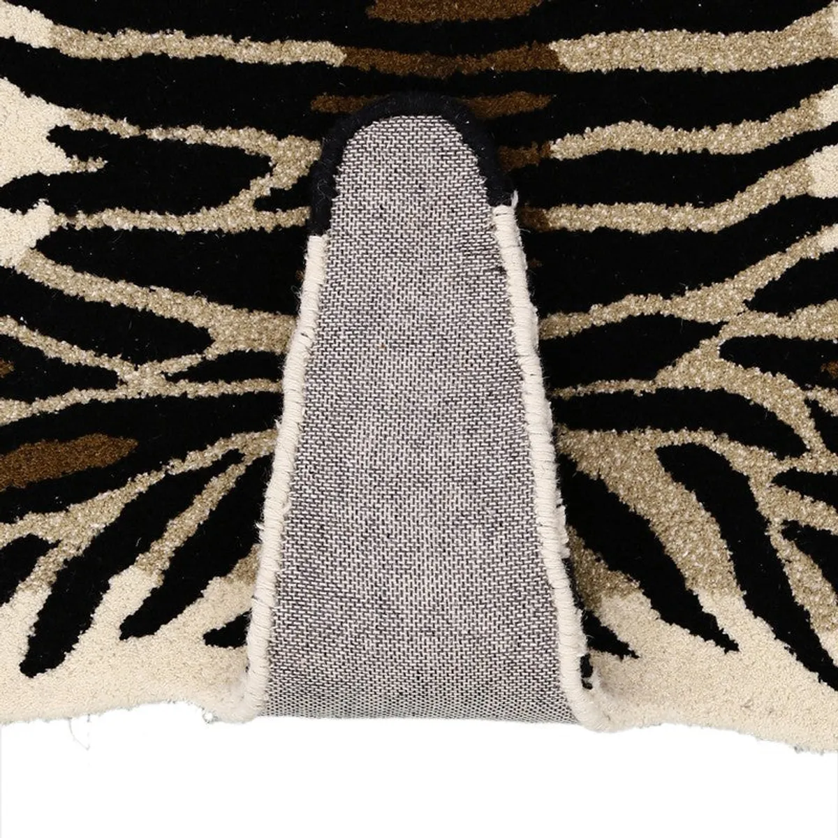 Close-up showing the carpet's textured underside and shaped edge