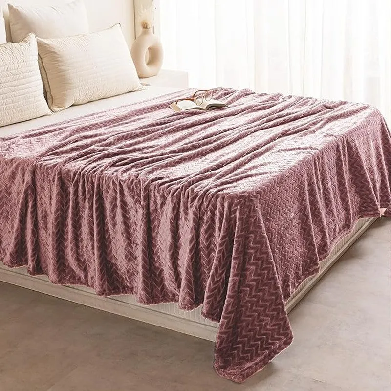 Peach textured blanket spread across a bed