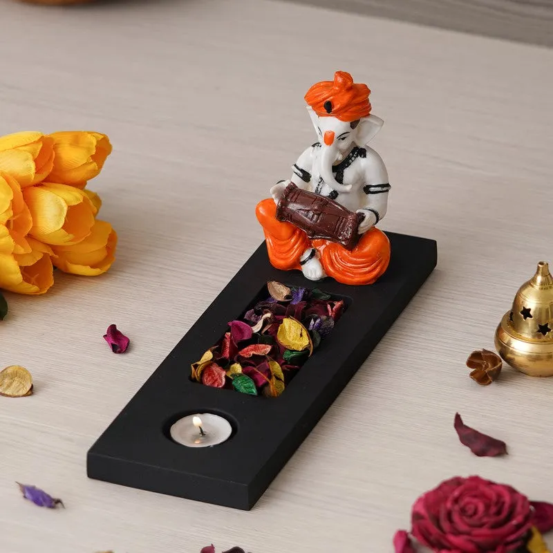 Angled view of Ganesha tea light holder with orange and white figurine