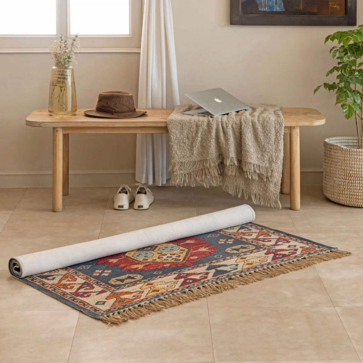 Multicolour patterned rug partially rolled on a tiled floor