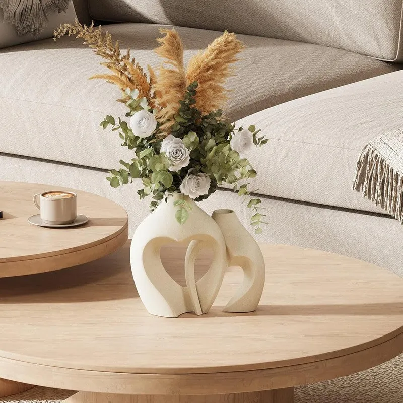 Pair of white abstract vases styled on a round wooden coffee table