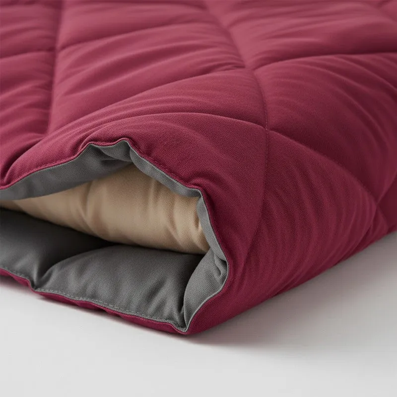 Close-up view of the maroon quilted comforter with grey reverse side