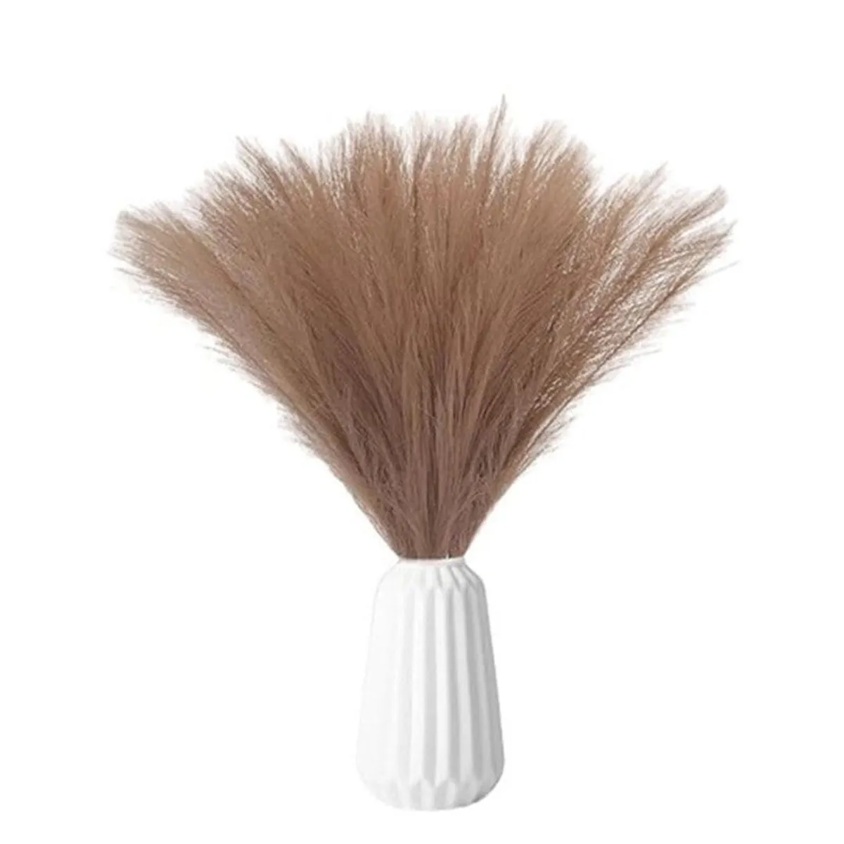 Brown feathery pampas grass displayed in a white ribbed vase
