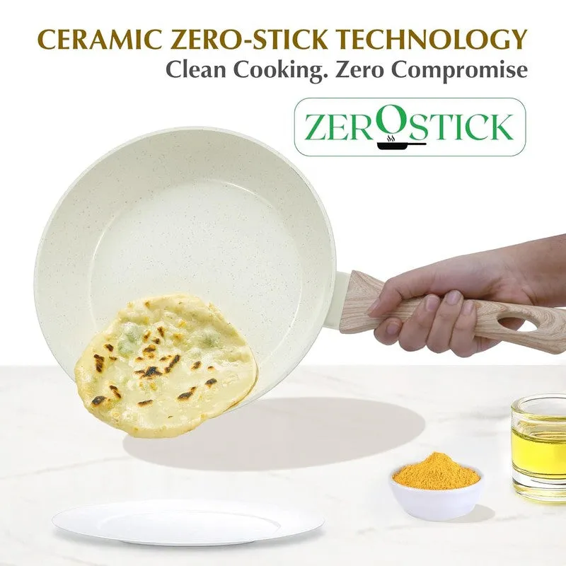 White speckled frying pan tilted with flatbread and wood-look handle