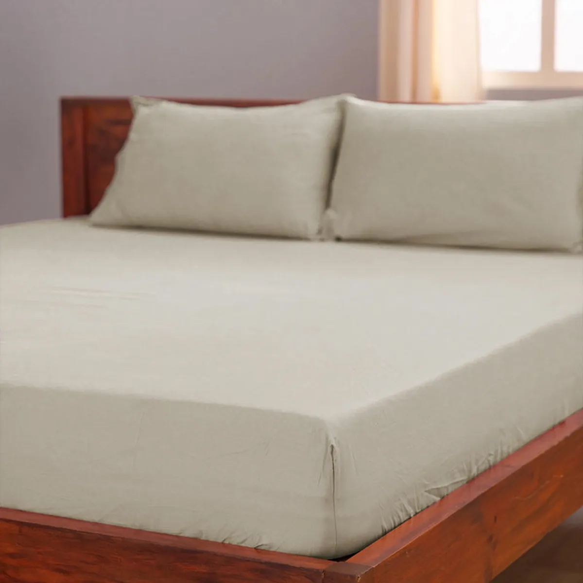 Beige flat sheet fitted over a wooden bed frame