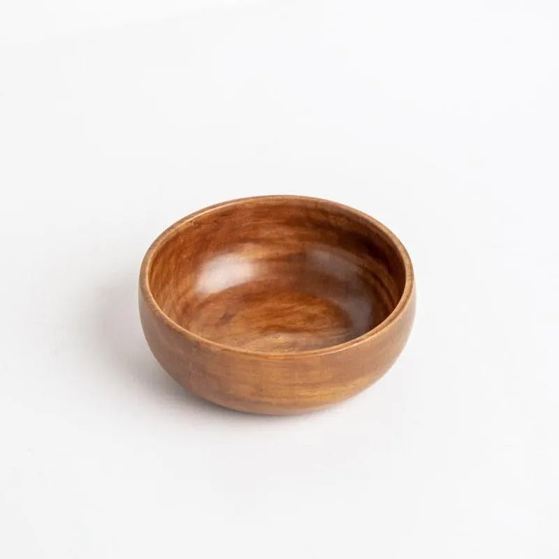 Single brown wooden bowl shown from above at an angle