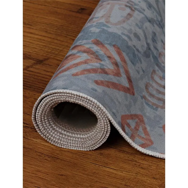 Rolled edge of blue and red carpet showing underside