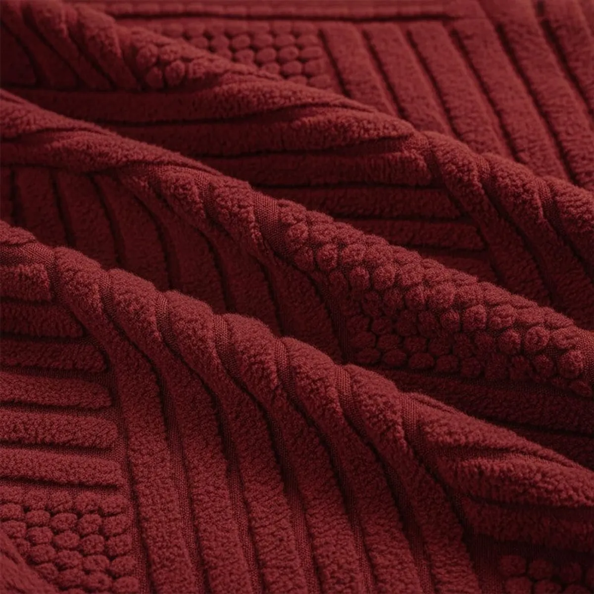 Close-up view of the maroon textured geometric chair cover fabric