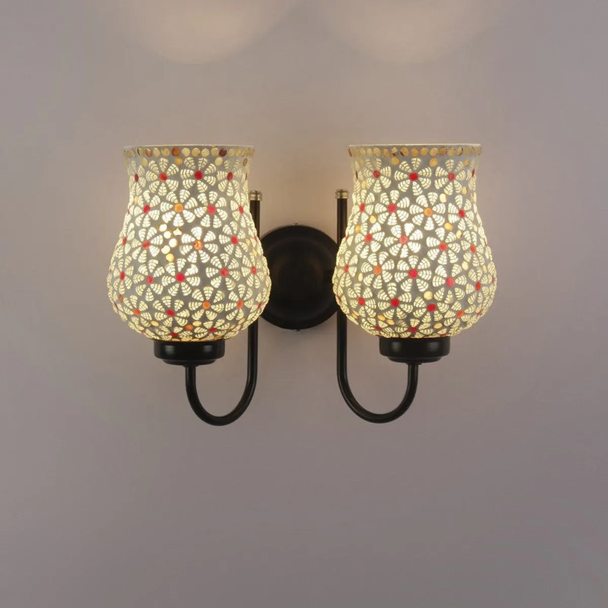Front view of lit white glass double wall lamp with black iron base