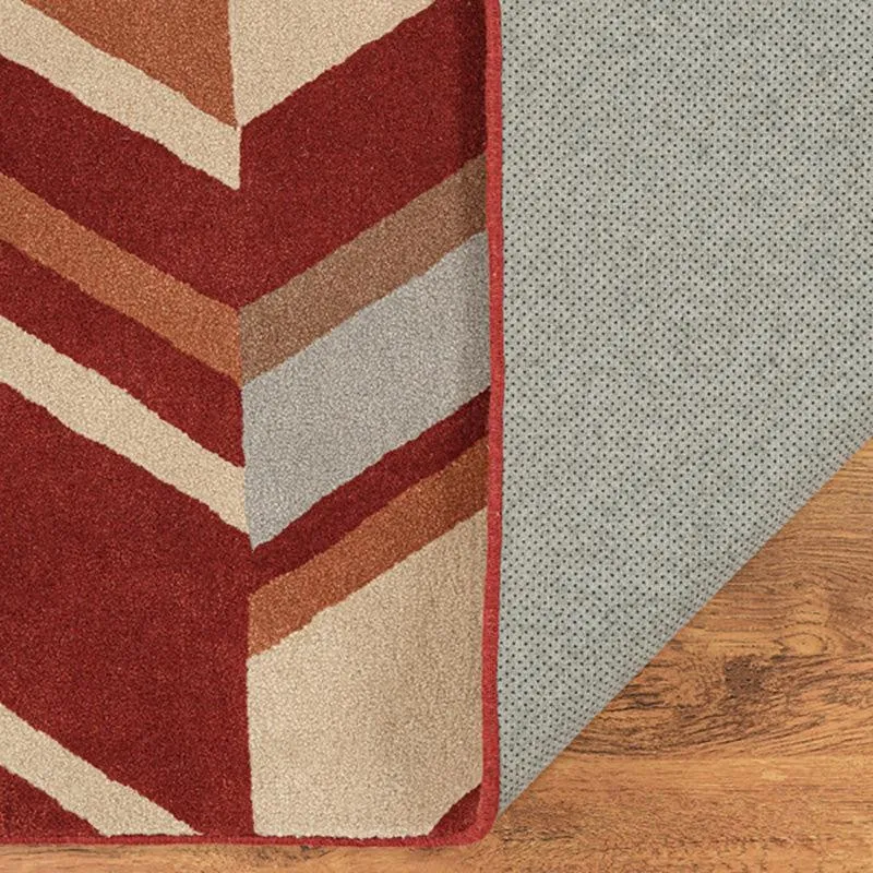 Corner of carpet showing patterned surface and grey underside