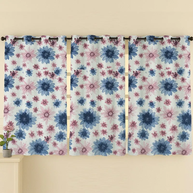 Three blue and pink floral curtains displayed across a wall.