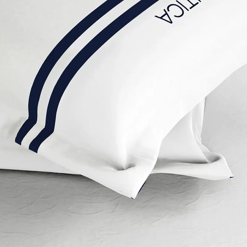 Close-up of white fabric with curved navy stripe detailing