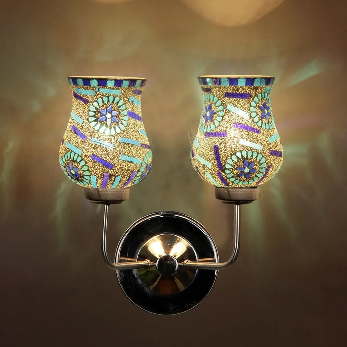 Close view of dual mosaic glass wall lamp casting warm light
